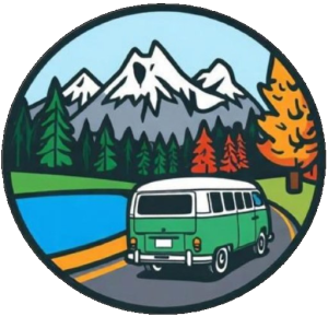 Dreckly Days Logo, features an old school green and white campervan driving along a winding lane past a lake, ahead are snow capped mountains with pine trees in the foothills and by the lake are trees in autumn colours